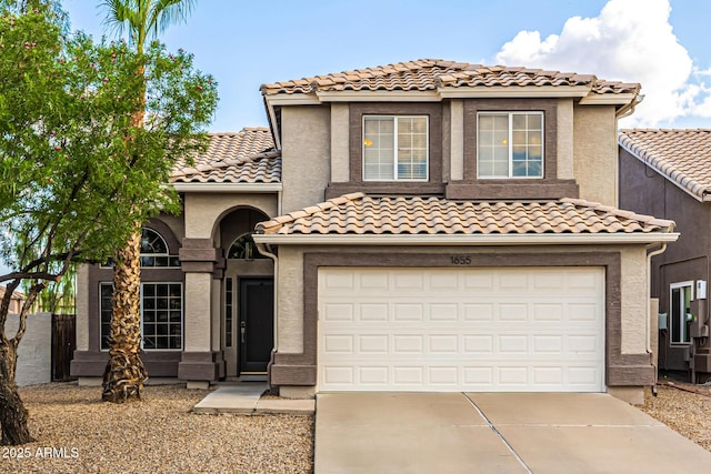 1655 W Stanford Ave, Gilbert, AZ 85233 - mediterranean / spanish-style home featuring driveway, a tile roof, an attached garage, and stucco siding
