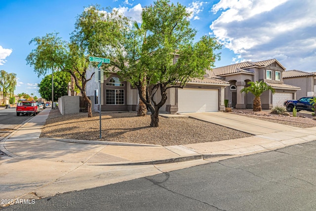 1655 W Stanford Ave, Gilbert, AZ 85233 - mediterranean / spanish-style home with driveway, stucco siding, an attached garage, and a tile roof