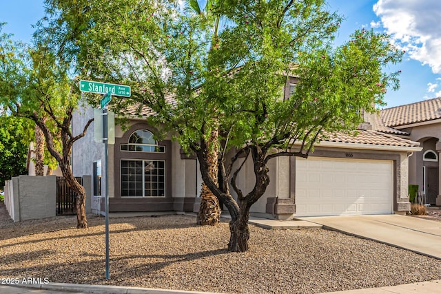 1655 W Stanford Ave, Gilbert, AZ 85233 - view of front of property with concrete driveway, an attached garage, stucco siding, and a tiled roof
