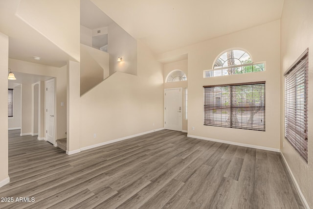 1655 W Stanford Ave, Gilbert, AZ 85233 - foyer featuring a towering ceiling, wood finished floors, and baseboards
