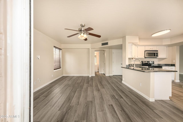 1655 W Stanford Ave, Gilbert, AZ 85233 - kitchen featuring appliances with stainless steel finishes, dark countertops, ceiling fan, white cabinetry, and dark wood finished floors