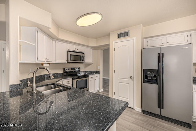 1655 W Stanford Ave, Gilbert, AZ 85233 - kitchen with stainless steel appliances, a sink, open shelves, white cabinetry, and light wood-type flooring