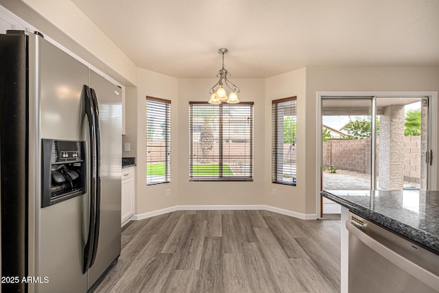 1655 W Stanford Ave, Gilbert, AZ 85233 - unfurnished dining area with wood finished floors, a chandelier, and baseboards