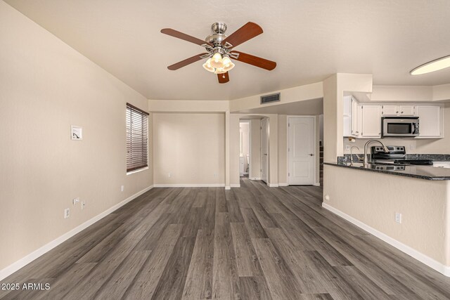 1655 W Stanford Ave, Gilbert, AZ 85233 - unfurnished living room featuring ceiling fan, dark wood-type flooring, and baseboards