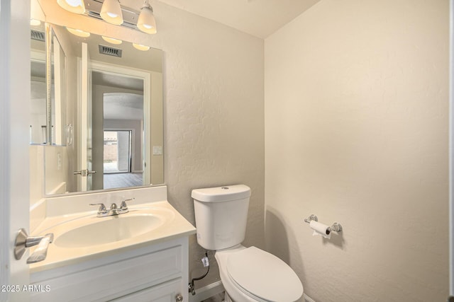 1655 W Stanford Ave, Gilbert, AZ 85233 - bathroom featuring a textured wall, toilet, and vanity