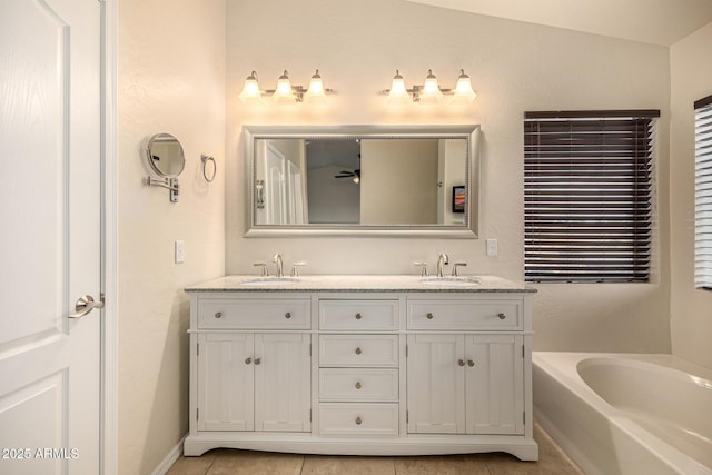 1655 W Stanford Ave, Gilbert, AZ 85233 - full bathroom featuring double vanity, a bath, tile patterned flooring, and baseboards