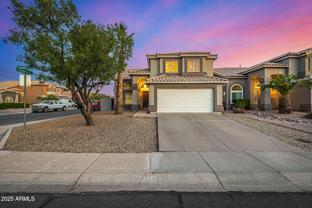 1655 W Stanford Ave, Gilbert, AZ 85233 - mediterranean / spanish-style house with a tile roof, concrete driveway, stucco siding, and an attached garage