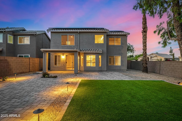 1655 W Stanford Ave, Gilbert, AZ 85233 - rear view of house with solar panels, a tiled roof, stucco siding, and a patio area