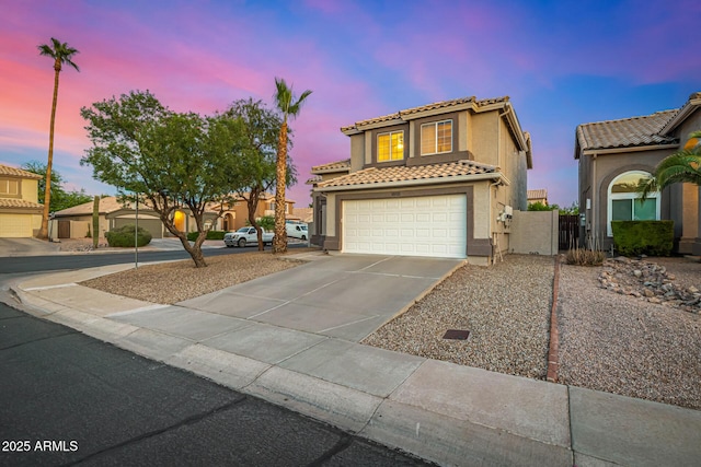 1655 W Stanford Ave, Gilbert, AZ 85233 - mediterranean / spanish-style house with concrete driveway, a tiled roof, stucco siding, an attached garage, and a gate