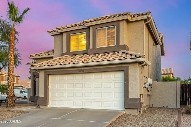 1655 W Stanford Ave, Gilbert, AZ 85233 - mediterranean / spanish-style house featuring an attached garage, concrete driveway, a tile roof, and stucco siding