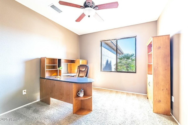 unfurnished office featuring ceiling fan and light carpet