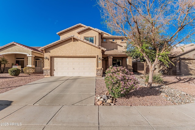 view of front of home with driveway, stone siding, a tiled roof, an attached garage, and stucco siding