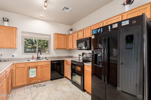 kitchen featuring black appliances, visible vents, light countertops, and a sink