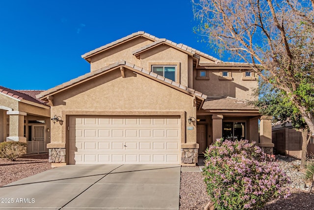 view of front of house featuring a garage, a tiled roof, concrete driveway, and stucco siding