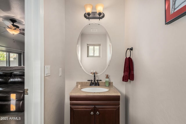 bathroom featuring a wealth of natural light, ceiling fan, and vanity