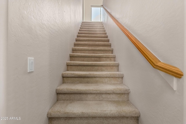 staircase with a textured wall