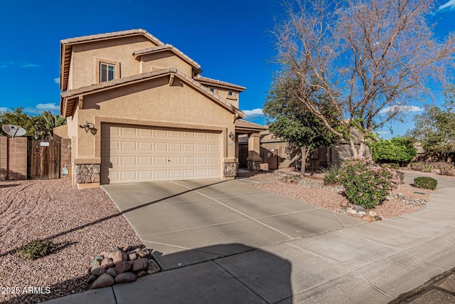 view of front facade featuring a garage, concrete driveway, a gate, and stucco siding