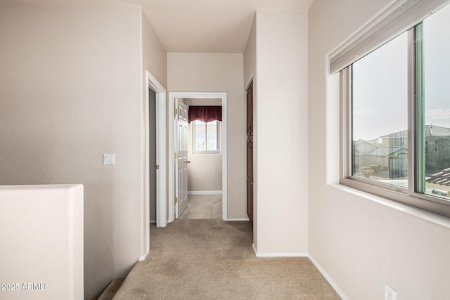 hall with carpet and baseboards