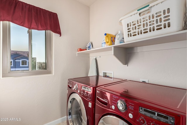 clothes washing area featuring laundry area, baseboards, and separate washer and dryer