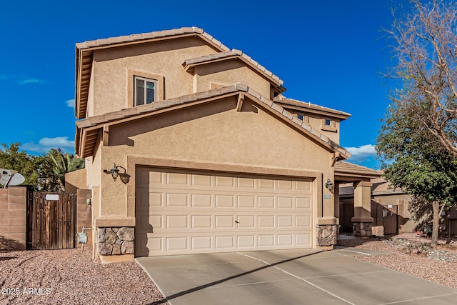 view of front of property featuring stone siding, driveway, and stucco siding