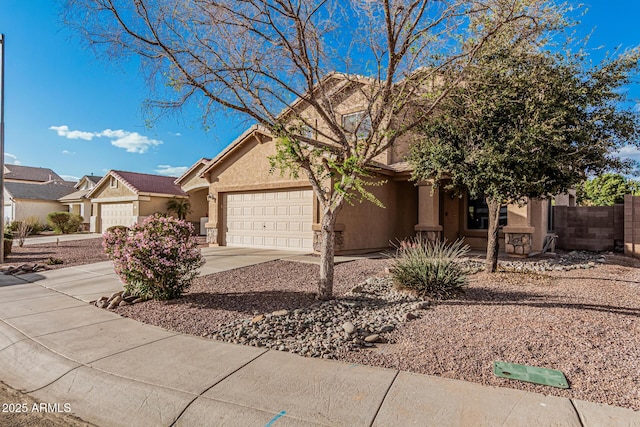 view of front of property with a garage, concrete driveway, fence, and stucco siding