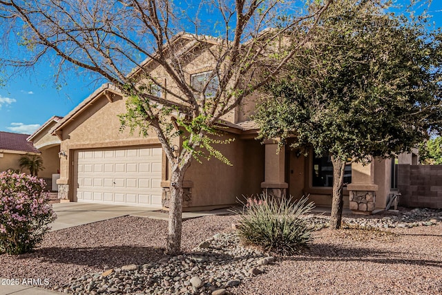 view of front of property featuring a garage, a tile roof, concrete driveway, and stucco siding