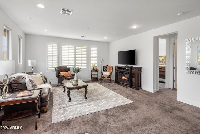 living room with a fireplace and carpet flooring