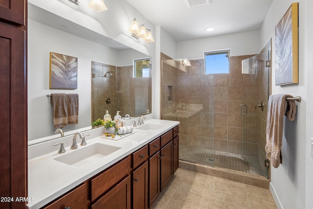 bathroom featuring vanity, tile patterned floors, and walk in shower