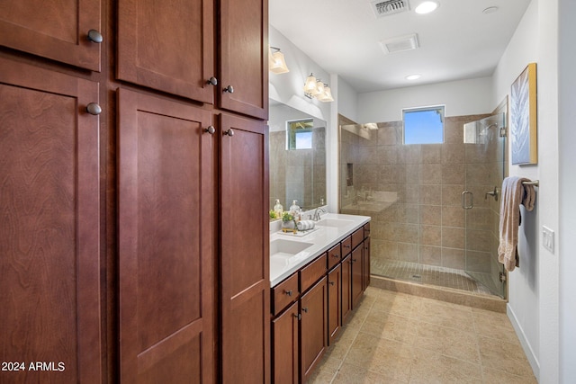 bathroom with vanity and a shower with door