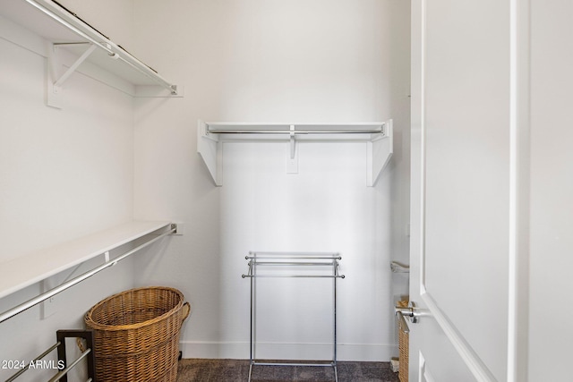 spacious closet featuring dark tile patterned floors