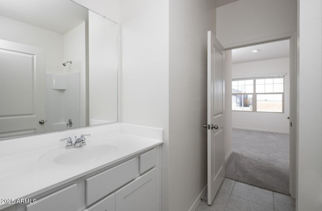 bathroom featuring tile patterned flooring, vanity, and walk in shower