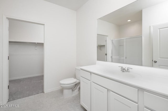 bathroom featuring an enclosed shower, vanity, and toilet