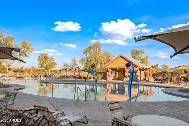 community pool featuring fence and a patio