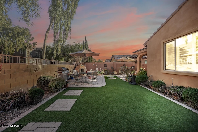 view of yard featuring a patio area and a fenced backyard