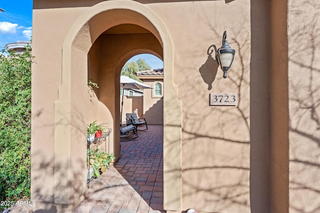 property entrance featuring a patio area and stucco siding