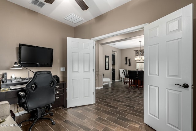 home office featuring ceiling fan with notable chandelier