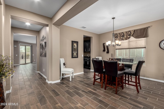 dining area with an inviting chandelier