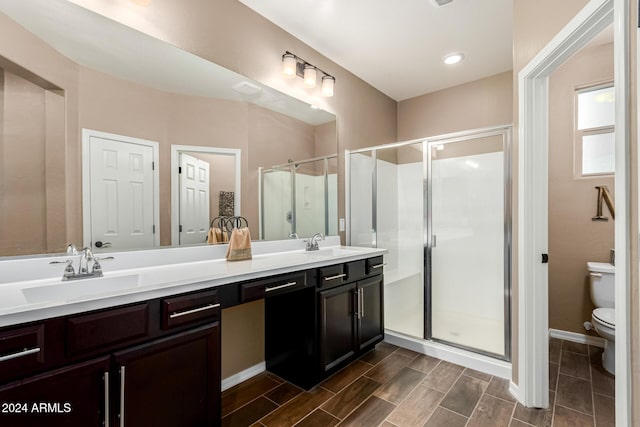 bathroom featuring walk in shower, vanity, and toilet