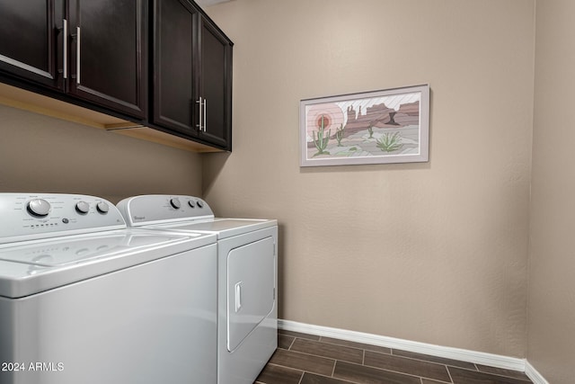 clothes washing area featuring cabinets and washing machine and dryer