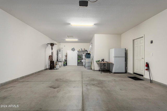 garage with white fridge and water heater