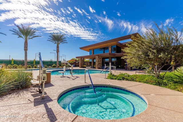 view of pool featuring a patio area and a community hot tub