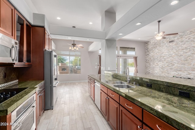 kitchen with stainless steel appliances, plenty of natural light, tasteful backsplash, and sink