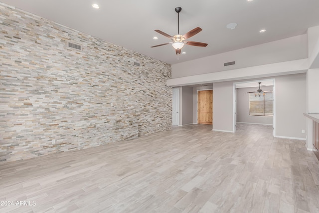 unfurnished living room with ceiling fan and light hardwood / wood-style flooring