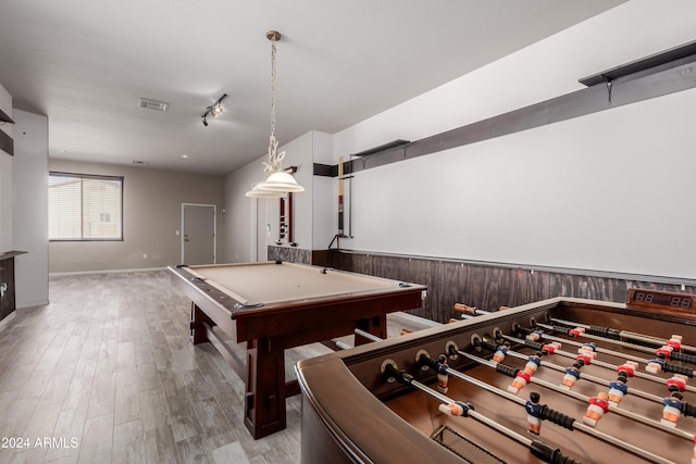 game room with light wood-type flooring, wood walls, and billiards