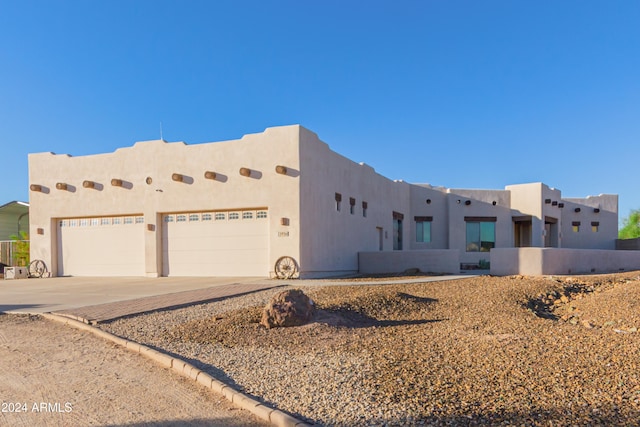 southwest-style home with a garage