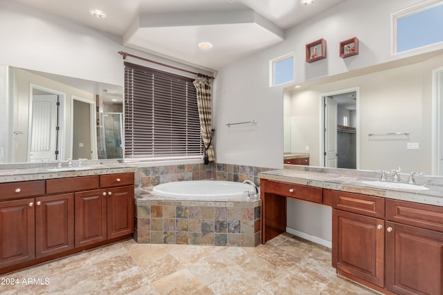 bathroom with shower with separate bathtub and vanity