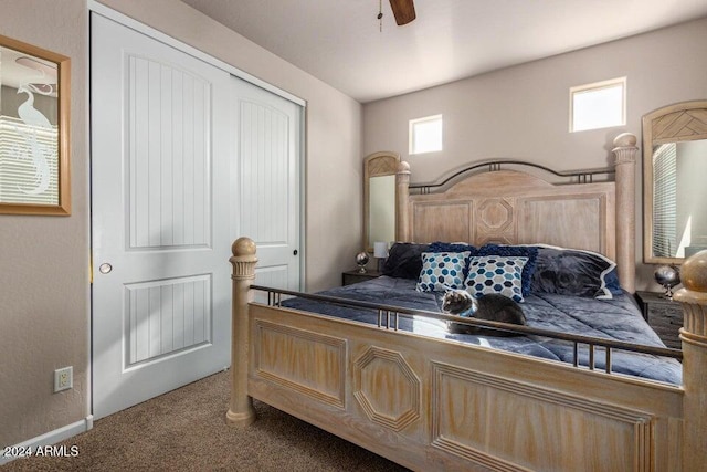 carpeted bedroom featuring a closet, multiple windows, and ceiling fan