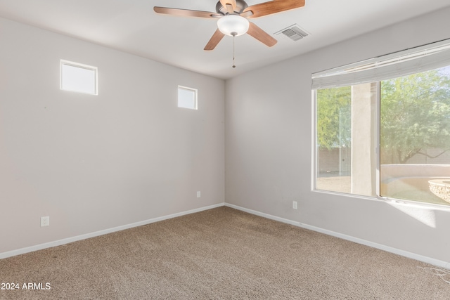 unfurnished room featuring ceiling fan and carpet floors