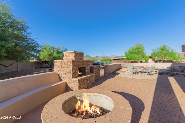 view of patio / terrace with a mountain view and area for grilling