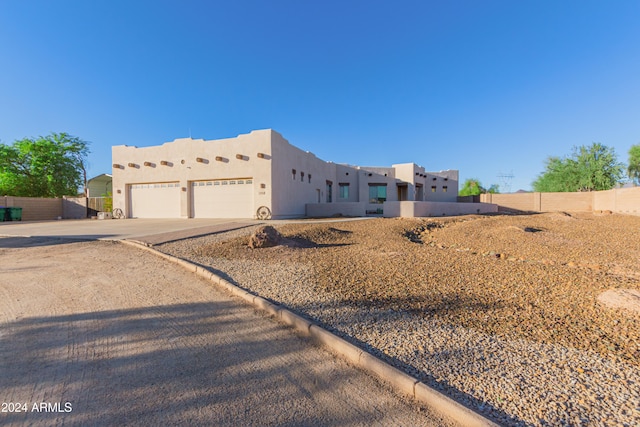 southwest-style home featuring a garage